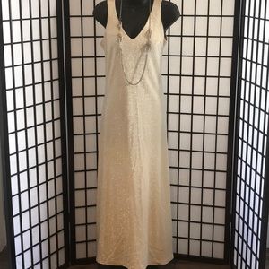 A long sleeveless yellow and silver dress